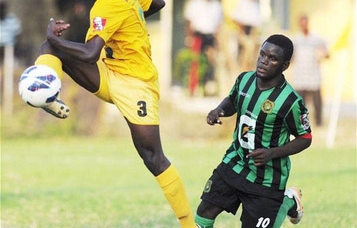 Excelsior High School's Hishrock Francis (left) kicks the ball while Calabar High's Kyle Scott tussles for possession during the ISSA/Gatorade/Digicel Manning Cup second-round football match at Constant Spring Complex yesterday. Excelsior won 2-0 - Ricardo Makyn/Staff Photographer