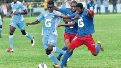 Kendon Anderson of St George’s College (second left) is double-teamed by two Clan Carthy players during their Manning Cup preliminary round match at Winchester Park on Saturday. Anderson scored four times in St George’s 15-0 victory. (Photo: Jermaine Barnaby)