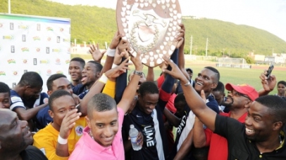 An elated Jamaica College team, supporters and sponsors lift the 2013 Olivier Shield. - Ricardo Makyn photo