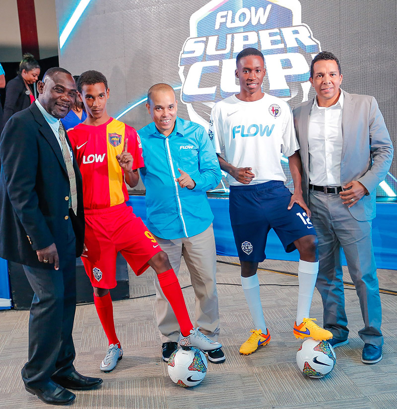 L-R - Dr. Walton Small , President of ISSA, David Shirley (centre) of Locker Room Sports Ltd and Carlo Redwood ( right), VP Marketing & Products at Flow Jamaica pose with students wearing the new ISSA/FLOW Super Cup kit sponsored by international sports apparel manufacturer, Nike. All player in the 2015 competition will receive full jersey kit including footwear. 