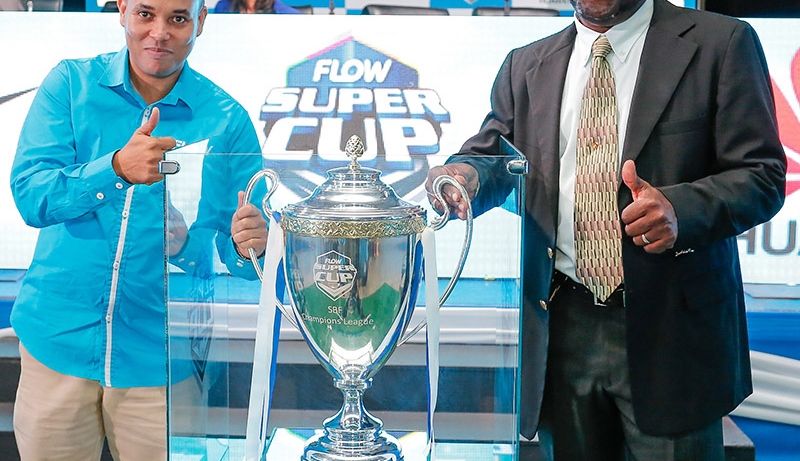 Carlo Redwood (left), Vice President - Marketing & Products at FLOW Jamaica and Dr. Walton Small, President of the Inter-Secondary School Sports Association ( ISSA) pose with the newly unveiled FLOW Super Cup trophy during the launch of the ISSA/FLOW Super Cup Competition held at the Montego Bay Convention Centre on Tuesday, October 6, 2015.