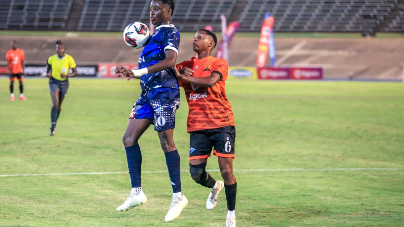 Game action between defending champions Jamaica College and Tivoli High